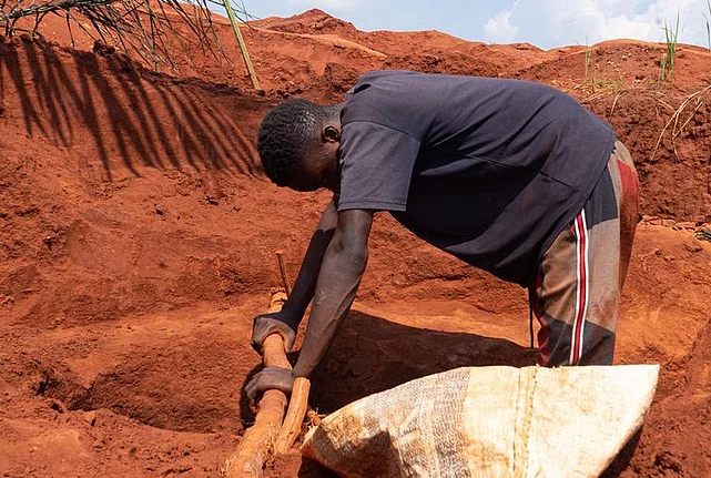 A worker in an open mining field